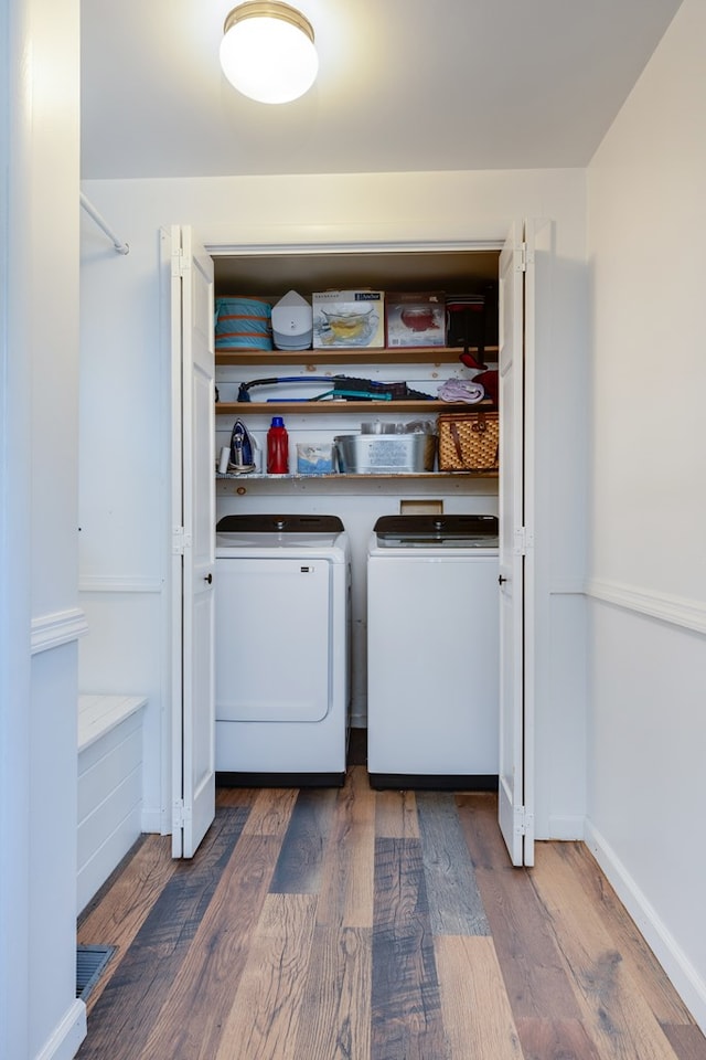 laundry area with dark wood-type flooring and washing machine and dryer