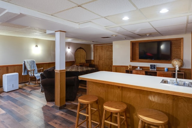 bar featuring sink, dark hardwood / wood-style flooring, and a drop ceiling