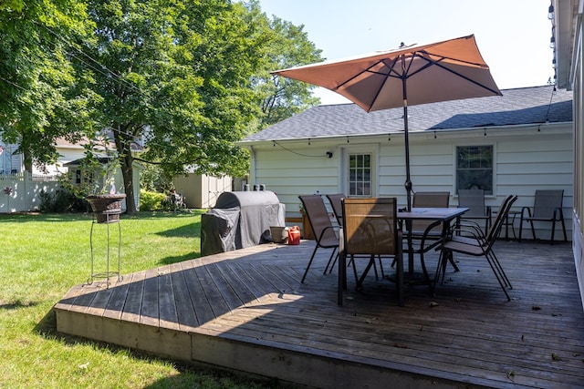 deck featuring a yard and a grill