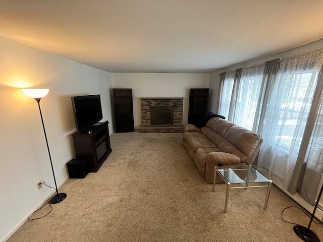 carpeted living room featuring a stone fireplace