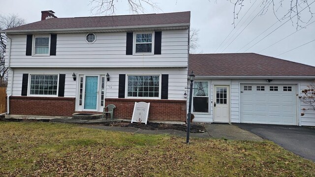 view of front of home featuring a front yard and a garage