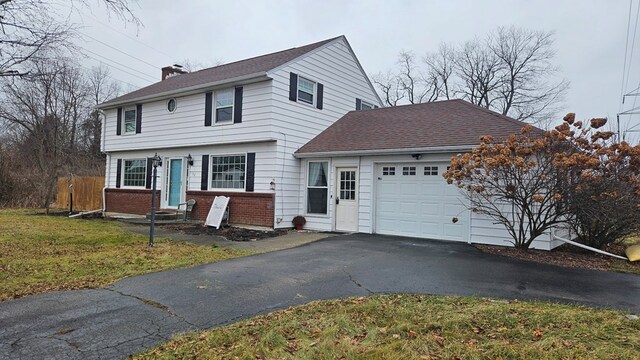 view of front of house with a front lawn and a garage