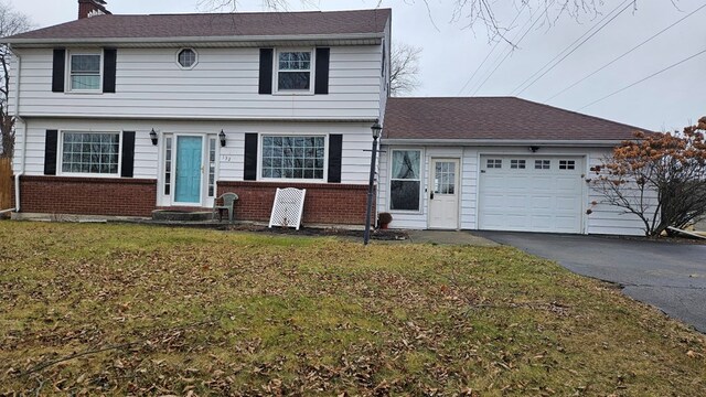 view of front of property with a garage and a front yard