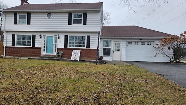 view of front of property featuring a garage and a front yard