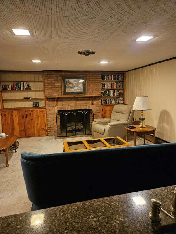 living room featuring a fireplace and built in shelves