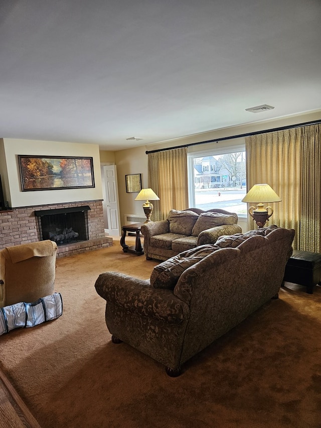 living room with carpet and a fireplace