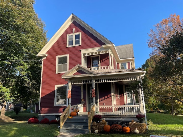 view of front of house with covered porch and a front yard