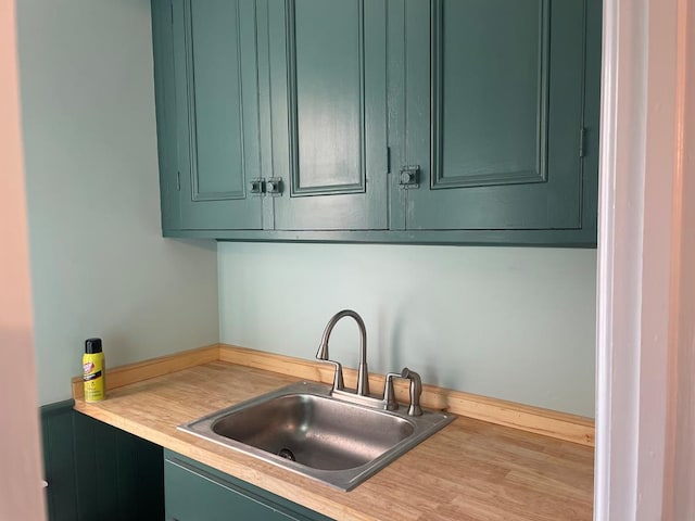 kitchen with sink and green cabinetry