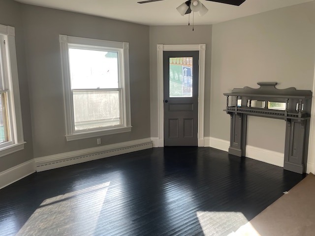 foyer entrance featuring a baseboard radiator, dark hardwood / wood-style floors, and ceiling fan