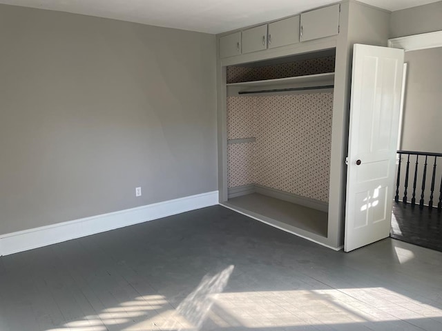 unfurnished bedroom featuring a closet and concrete flooring