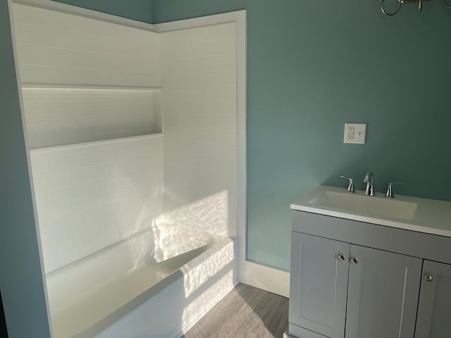 bathroom featuring a bathing tub, vanity, and wood-type flooring