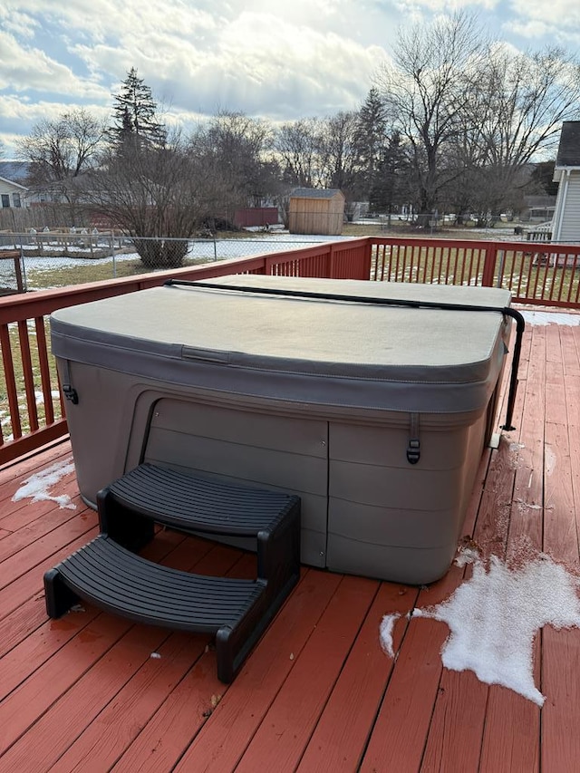 wooden deck featuring a hot tub