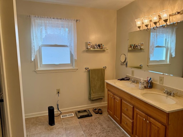 bathroom featuring tile patterned flooring and vanity