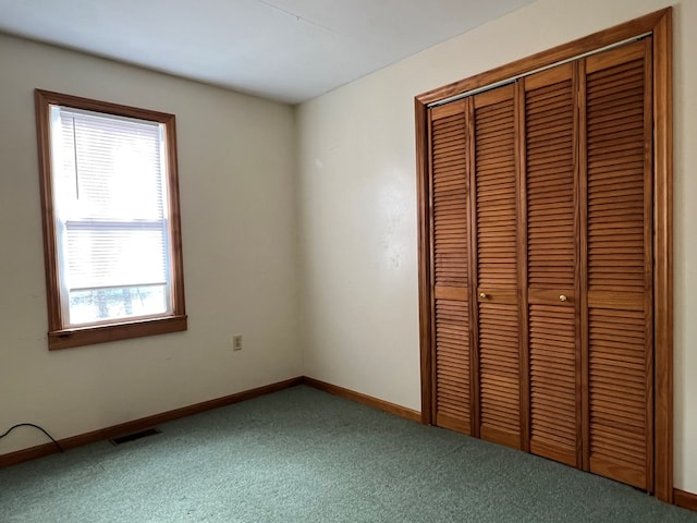 unfurnished bedroom featuring a closet and carpet flooring