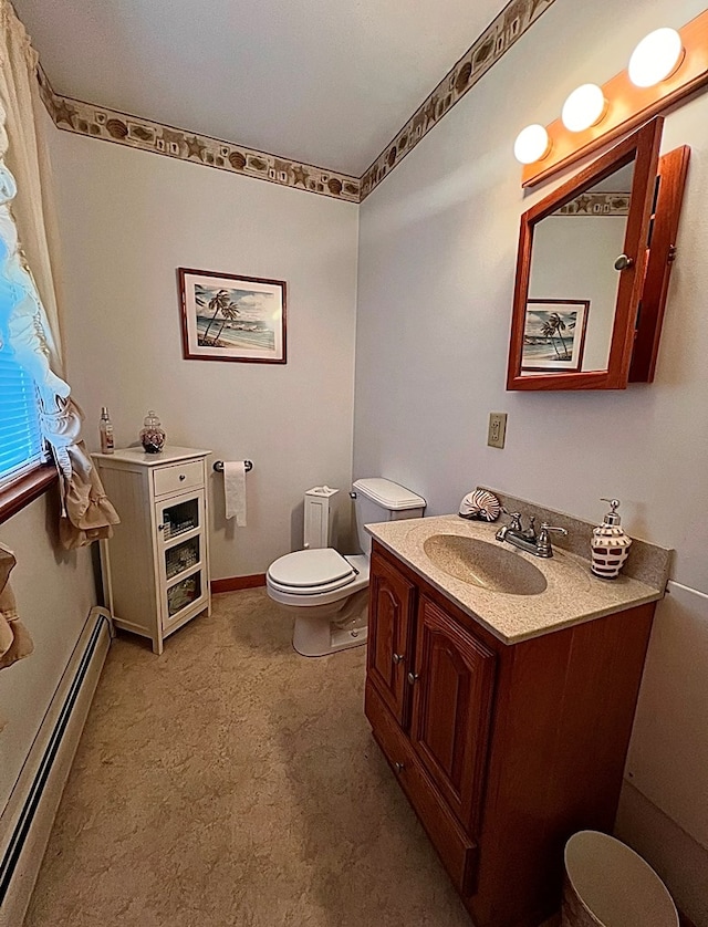 bathroom with vanity, toilet, and a baseboard heating unit