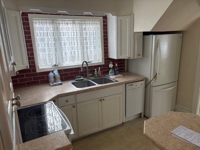 kitchen with white appliances, white cabinetry, tasteful backsplash, and sink