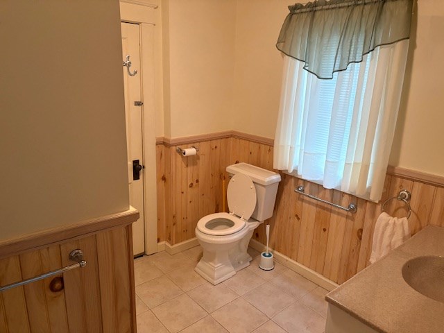 bathroom with tile patterned flooring, vanity, and toilet