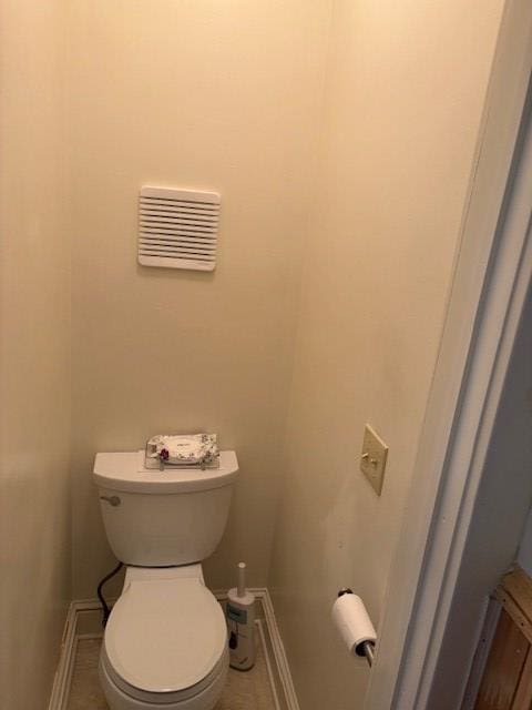 bathroom featuring toilet and tile patterned floors