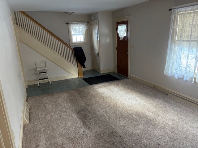 view of carpeted foyer entrance