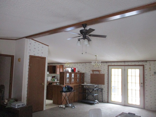 living room featuring ceiling fan with notable chandelier, a textured ceiling, vaulted ceiling with beams, and light colored carpet