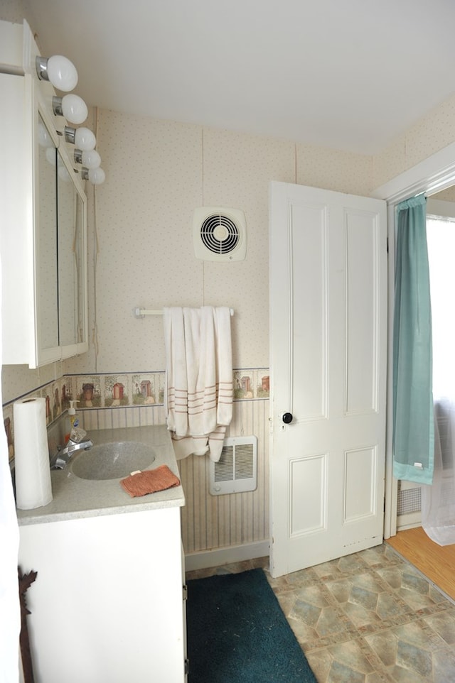 bathroom with vanity and heating unit