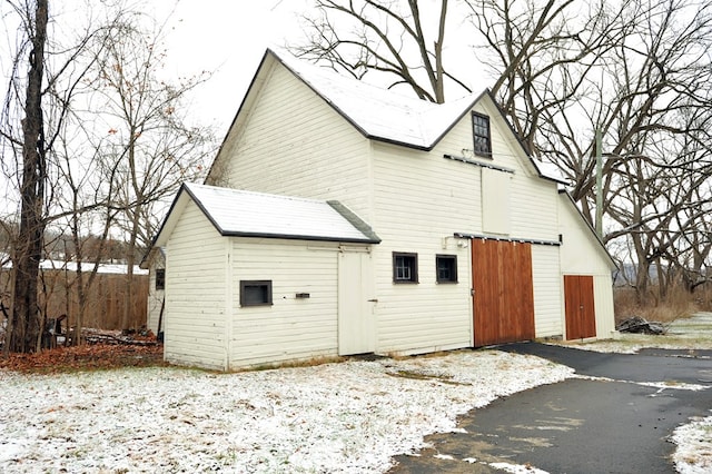 view of snow covered rear of property