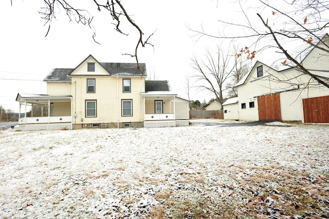 rear view of house featuring covered porch