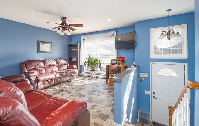 living room with ceiling fan with notable chandelier and a baseboard radiator