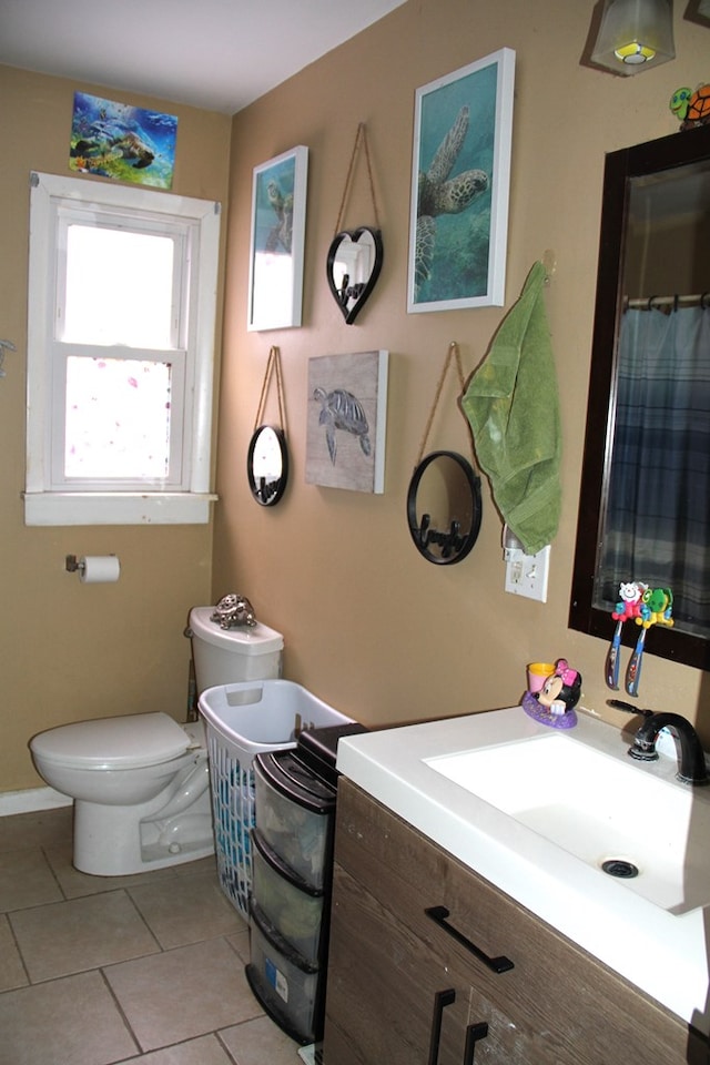 bathroom featuring tile patterned floors, toilet, and vanity