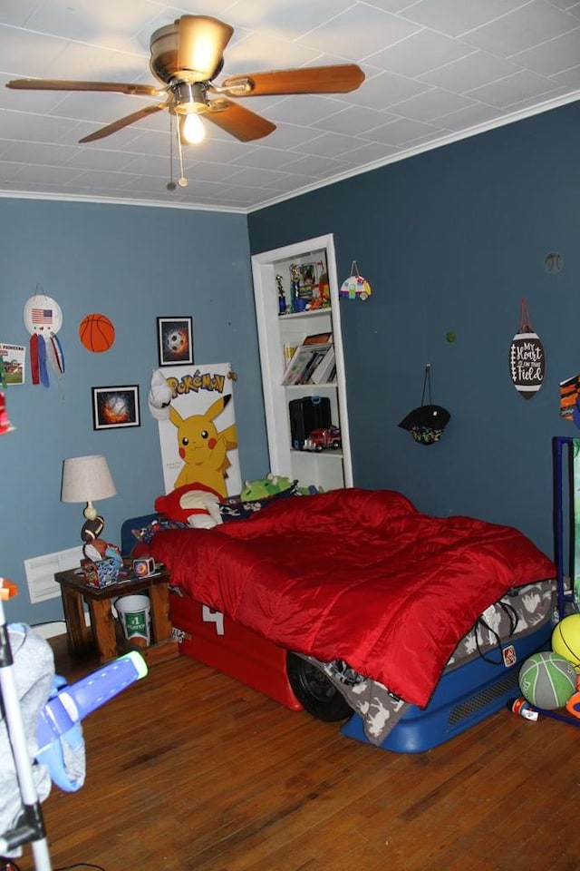 bedroom featuring crown molding and wood-type flooring