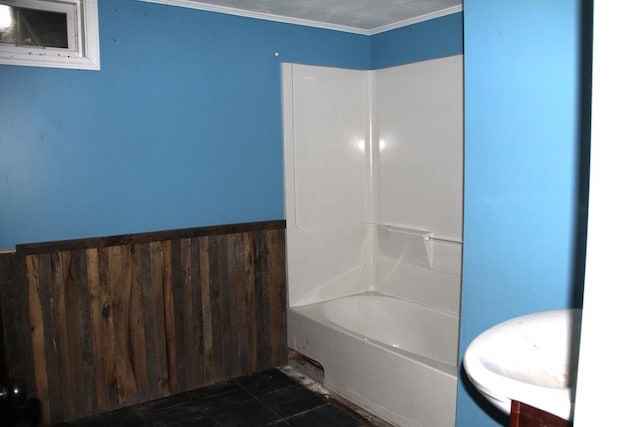 bathroom with tile patterned flooring, ornamental molding, and washtub / shower combination