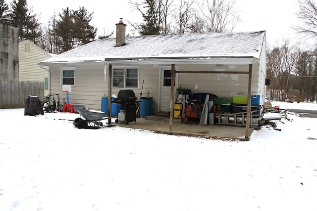 view of snow covered rear of property