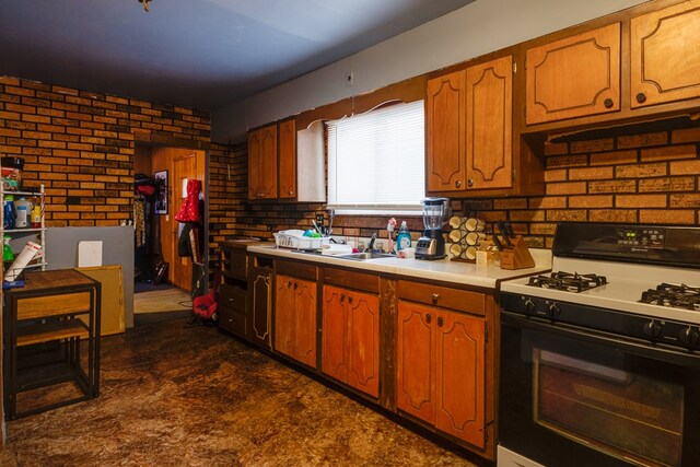 kitchen with brick wall and gas stove