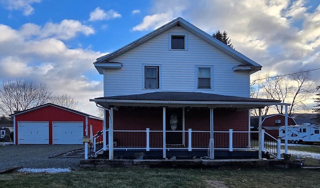 view of front facade with a garage, an outdoor structure, and covered porch