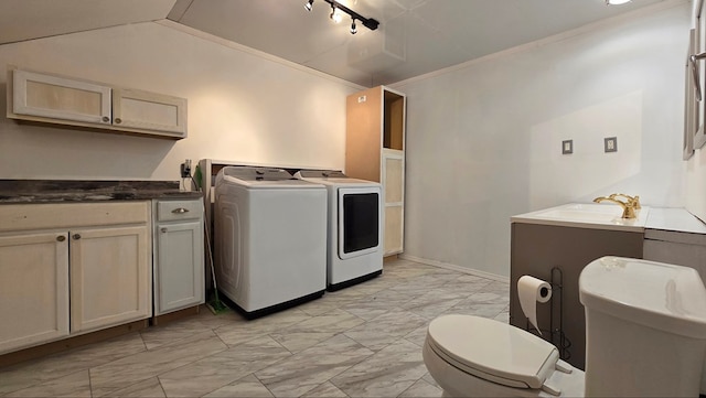 washroom with independent washer and dryer, ornamental molding, rail lighting, and sink