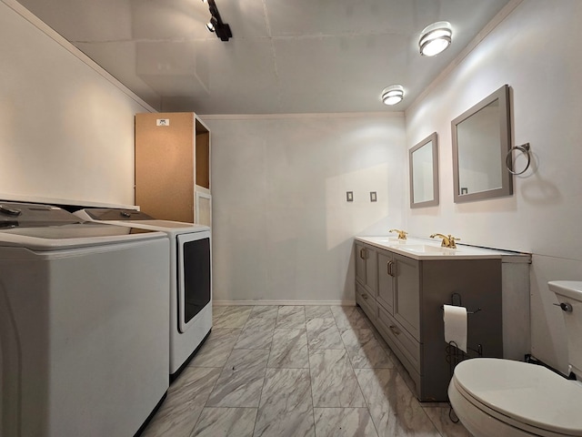 laundry area featuring independent washer and dryer and ornamental molding