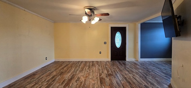 foyer entrance featuring dark hardwood / wood-style flooring, crown molding, and ceiling fan