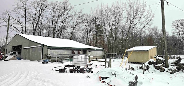 snowy yard featuring a shed