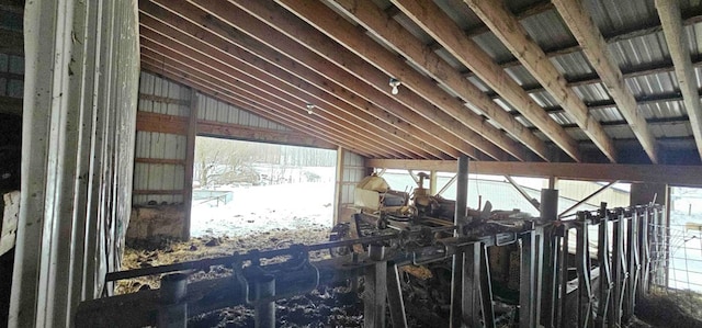 miscellaneous room featuring wooden walls and lofted ceiling