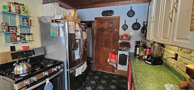 kitchen with gas stove and white cabinetry