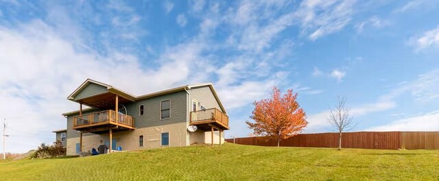 back of house with a lawn