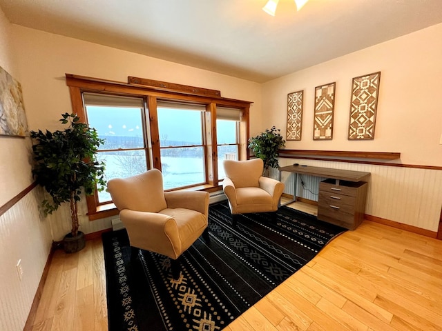 living area featuring baseboard heating and light wood-type flooring