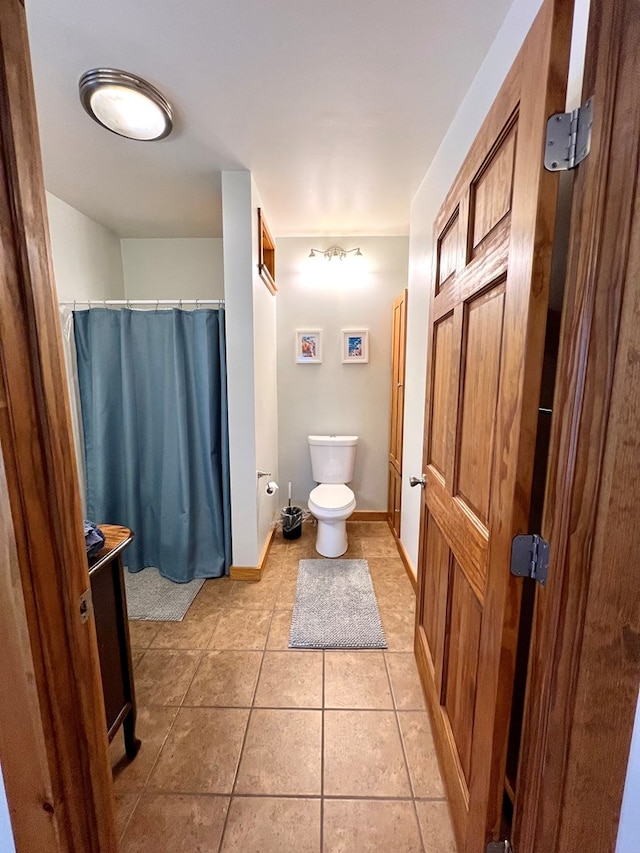 bathroom with vanity, tile patterned floors, toilet, and a shower with shower curtain