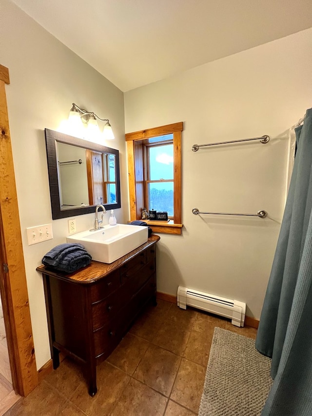 bathroom with a baseboard radiator, tile patterned floors, and vanity