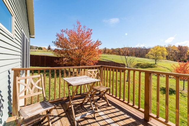 wooden terrace featuring a yard