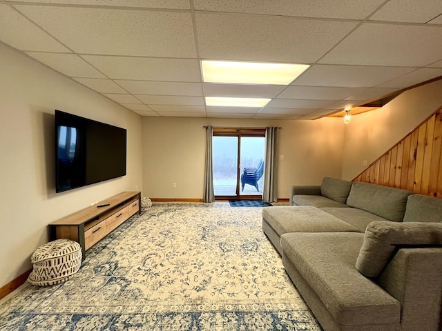 living room with a drop ceiling and carpet floors