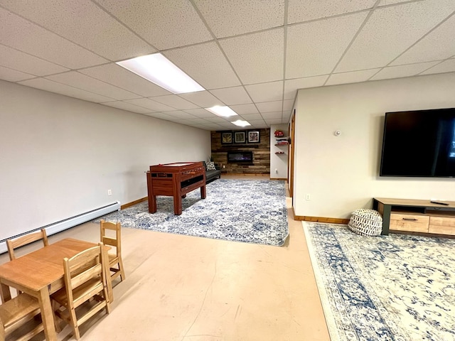 rec room with a baseboard heating unit and a paneled ceiling