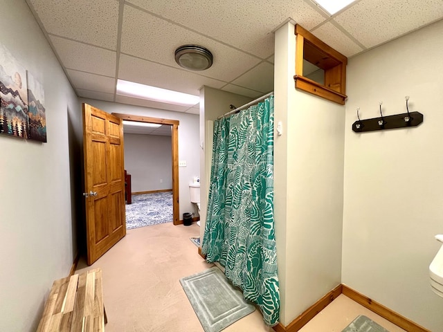 bathroom featuring a shower with curtain and a paneled ceiling