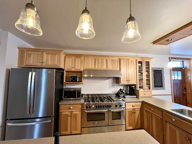 kitchen featuring pendant lighting, sink, tasteful backsplash, and appliances with stainless steel finishes