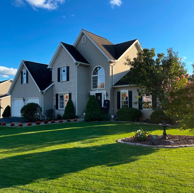 view of front of property featuring a front lawn and a garage